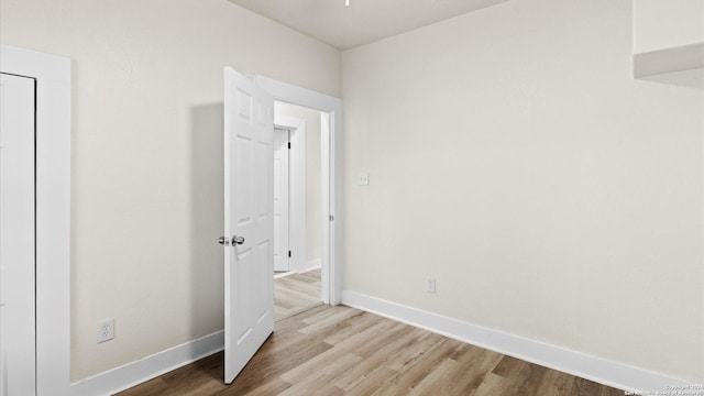 unfurnished bedroom with light wood-type flooring