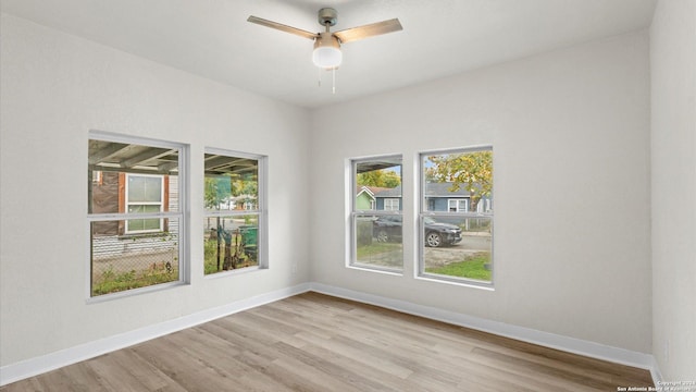 spare room with ceiling fan and light wood-type flooring