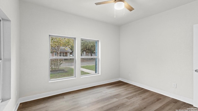 spare room with hardwood / wood-style floors and ceiling fan