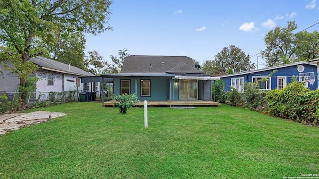 rear view of house with a lawn and a deck