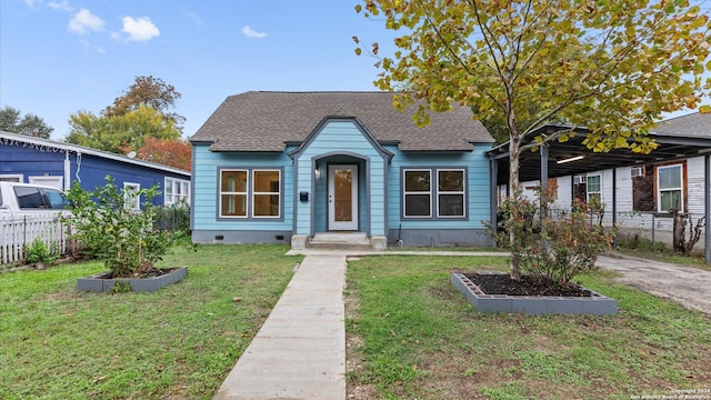 bungalow-style home with a front lawn and a carport