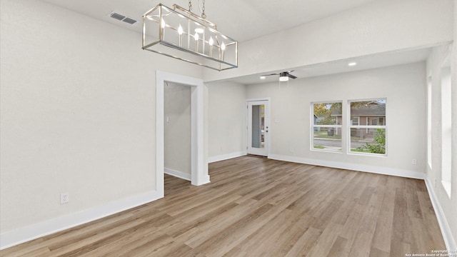 interior space featuring a chandelier and light hardwood / wood-style floors