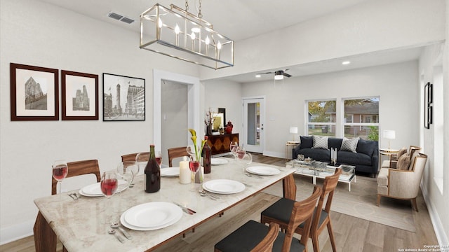 dining room featuring light hardwood / wood-style flooring and a notable chandelier