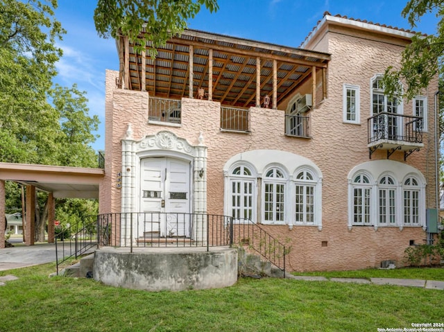 exterior space featuring a carport and a front yard