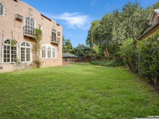 view of yard featuring an AC wall unit