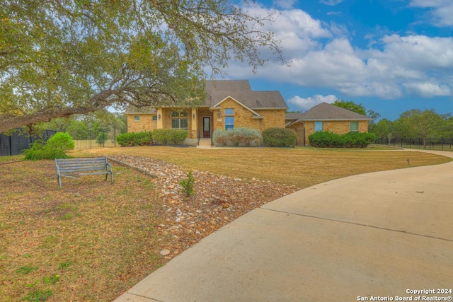 single story home featuring a front yard