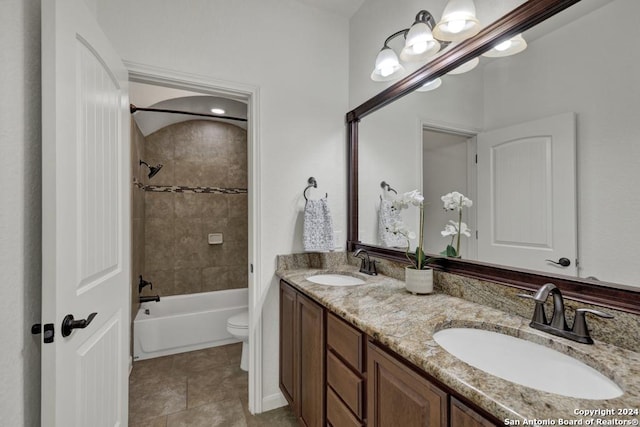 full bathroom with vanity, tiled shower / bath combo, and toilet