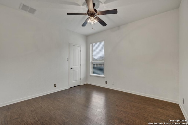 empty room with ceiling fan and dark wood-type flooring