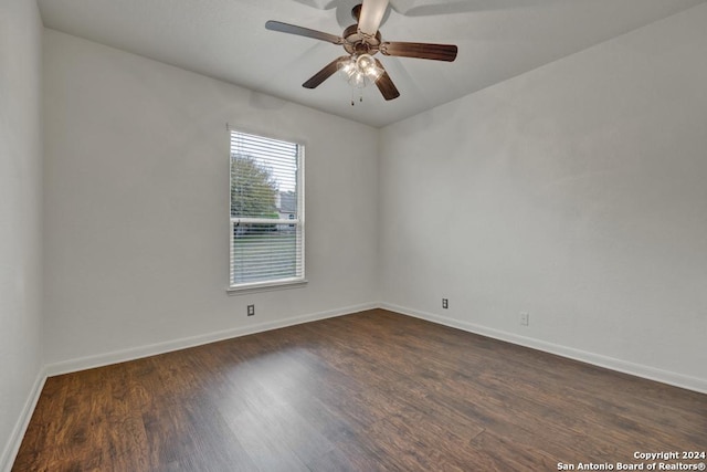 spare room with ceiling fan and dark wood-type flooring