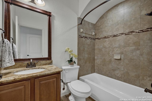 full bathroom with vanity, tiled shower / bath combo, and toilet