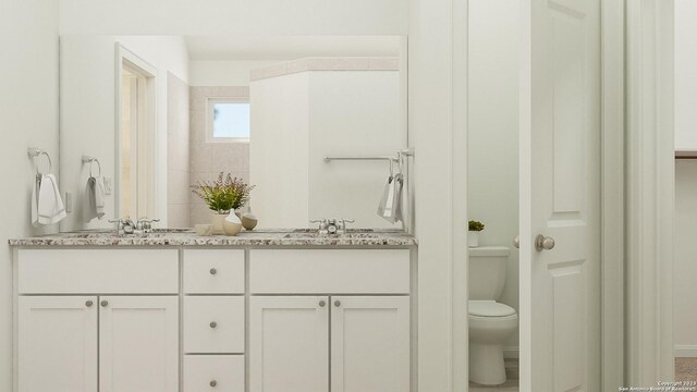 bathroom featuring vanity and toilet