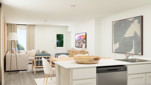 kitchen with white cabinets, dishwasher, light wood-type flooring, and sink