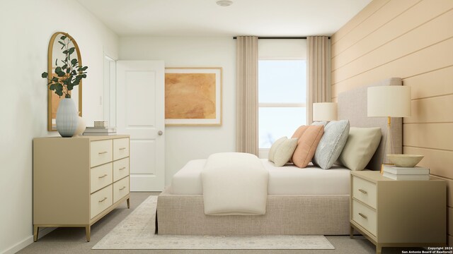 bedroom featuring light colored carpet and multiple windows