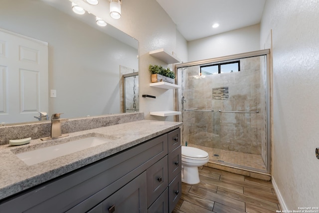 bathroom with vanity, an enclosed shower, and toilet