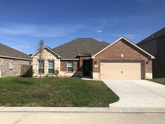 view of front facade featuring a front yard and a garage