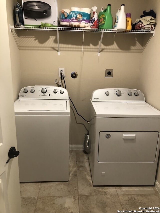 laundry area featuring washer and dryer and light tile patterned flooring