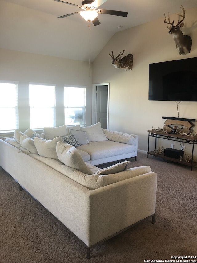 living room featuring dark colored carpet, ceiling fan, and vaulted ceiling