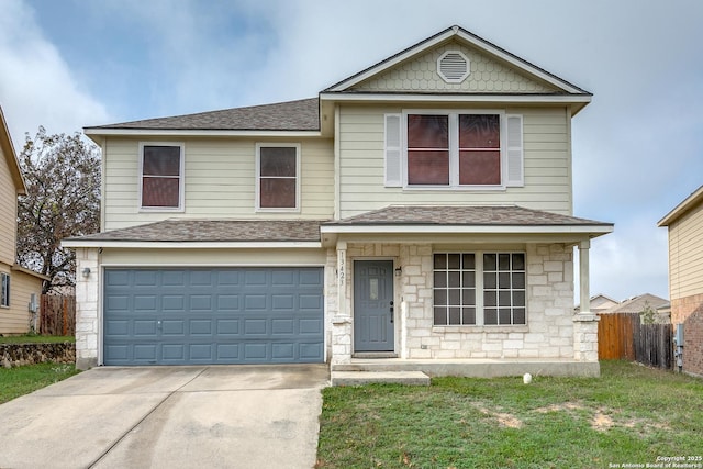 view of property with a garage and a front lawn