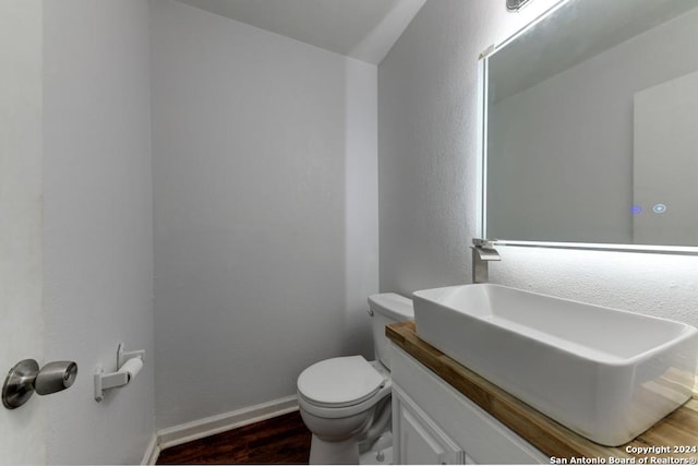 bathroom featuring hardwood / wood-style floors, vanity, and toilet