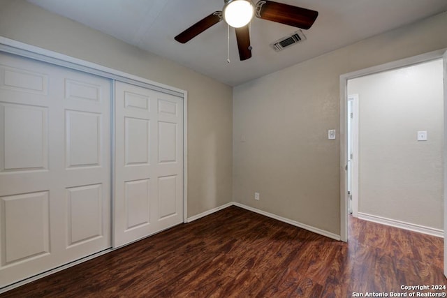 unfurnished bedroom featuring ceiling fan, a closet, and dark hardwood / wood-style floors