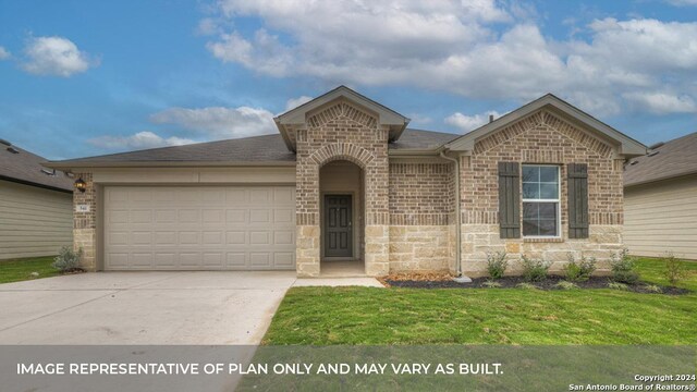 view of front facade with a garage and a front lawn