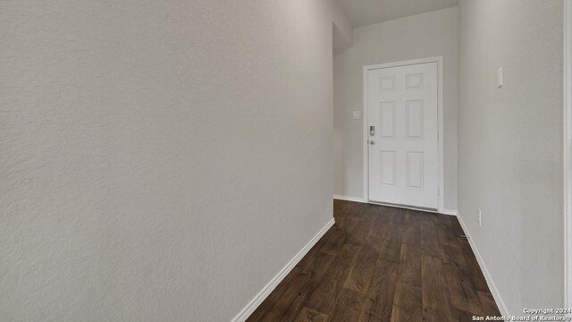 hallway with dark hardwood / wood-style flooring