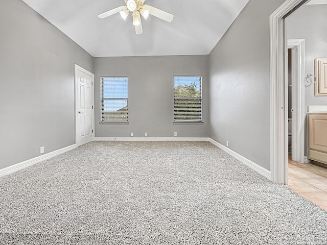 carpeted spare room with ceiling fan