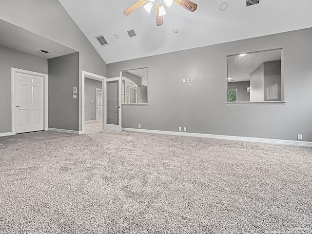 spare room with carpet, ceiling fan, french doors, and vaulted ceiling