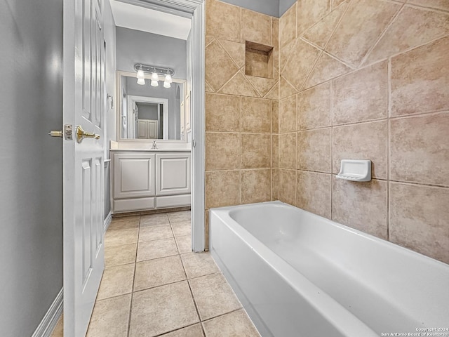 bathroom featuring vanity, tile patterned floors, and a tub