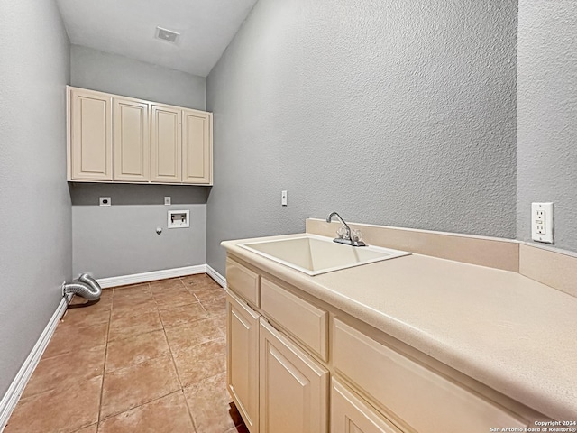 laundry room featuring hookup for an electric dryer, washer hookup, cabinets, sink, and light tile patterned floors