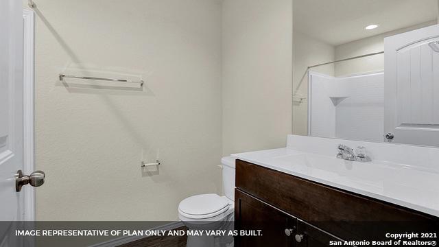 bathroom with vanity, toilet, and walk in shower