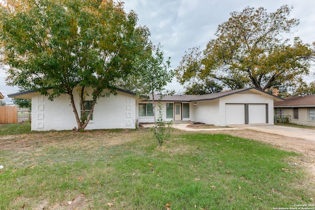 ranch-style home featuring a garage and a front yard