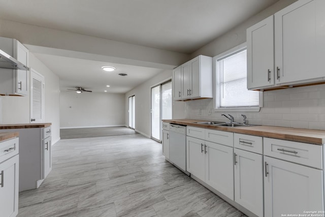 kitchen with wood counters, white dishwasher, ceiling fan, sink, and white cabinets