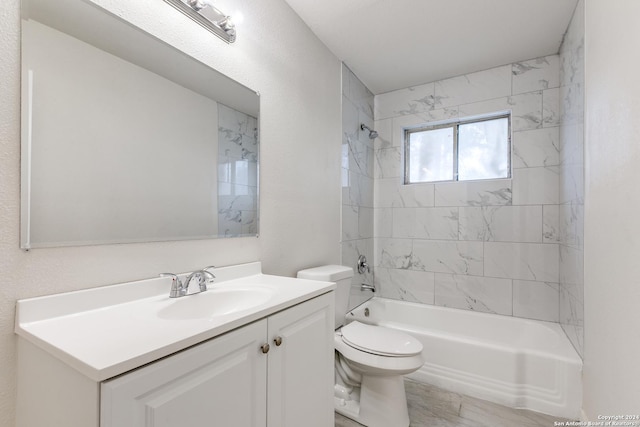 full bathroom featuring vanity, toilet, and tiled shower / bath