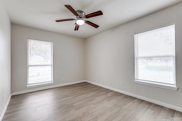 empty room featuring ceiling fan and light hardwood / wood-style floors