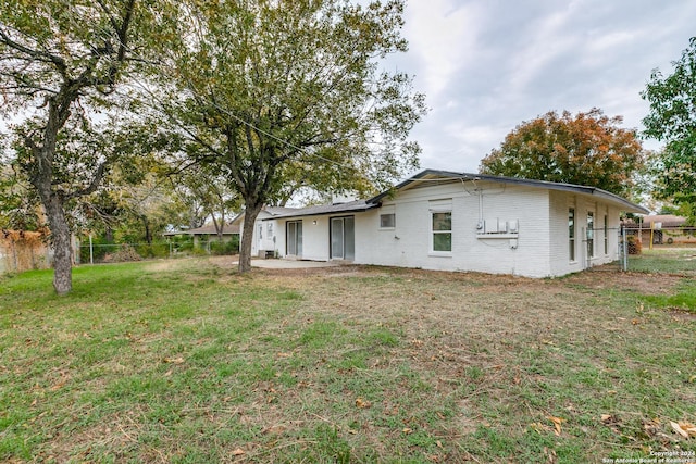 back of house with a yard