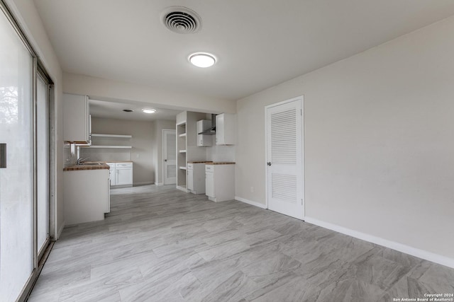 unfurnished living room featuring sink