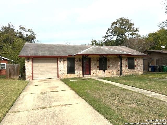 ranch-style home with a front yard and a garage