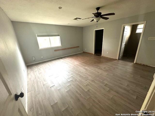 spare room with ceiling fan and wood-type flooring