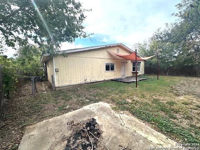 back of property featuring a lawn