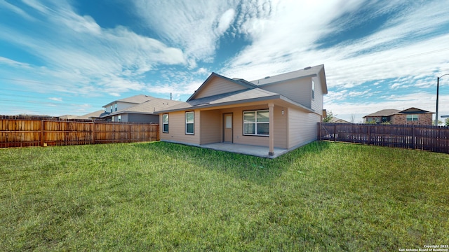 back of house featuring a yard and a patio area