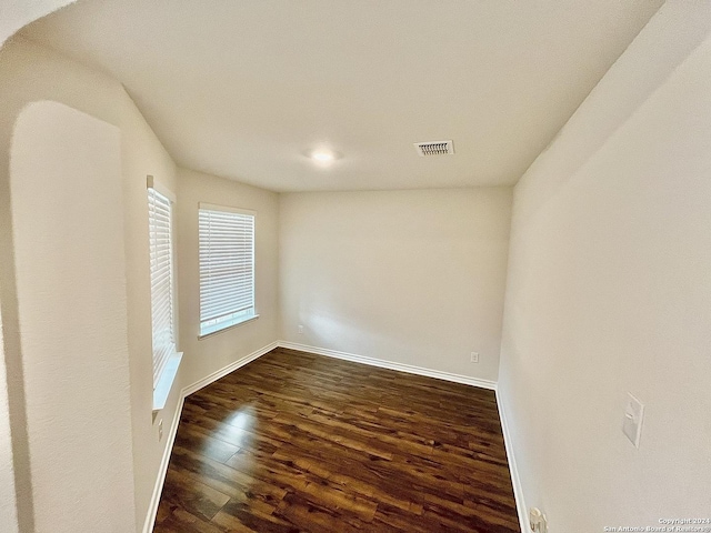 unfurnished room featuring dark hardwood / wood-style flooring