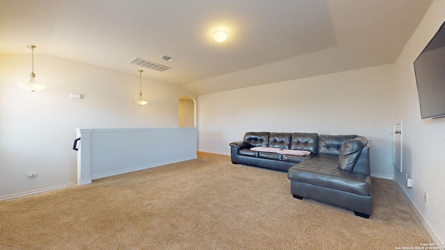 living area with light carpet and vaulted ceiling