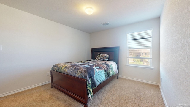 bedroom with light colored carpet