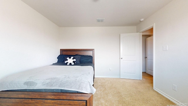 bedroom featuring light colored carpet