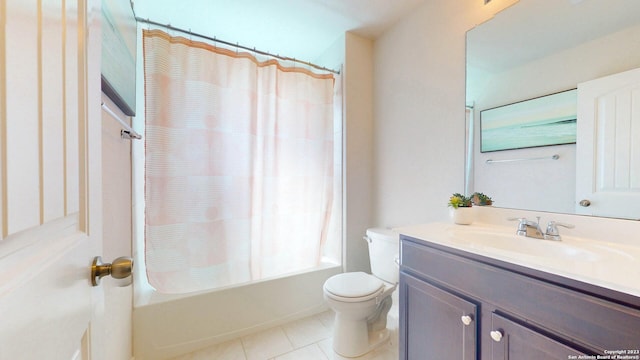 full bathroom with tile patterned floors, shower / bath combo with shower curtain, vanity, and toilet