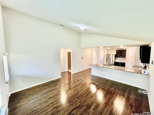 unfurnished living room featuring dark hardwood / wood-style floors, lofted ceiling, and sink