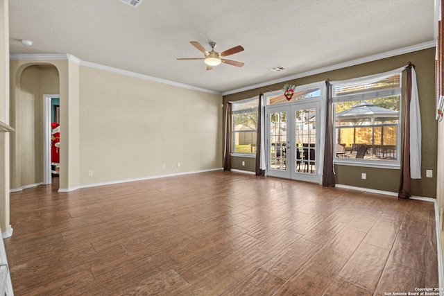 unfurnished room featuring hardwood / wood-style floors, plenty of natural light, a textured ceiling, and french doors