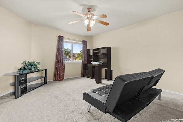 sitting room featuring light colored carpet and ceiling fan