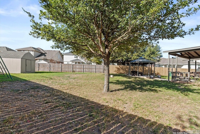 view of yard with a gazebo and a storage unit